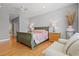 Bedroom featuring wood floors, a decorative bedspread, a seating area, and neutral paint at 5373 Anthony Ln, Sarasota, FL 34233