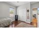 Bedroom boasts wood floors, a ceiling fan, a large window, and a double closet at 5373 Anthony Ln, Sarasota, FL 34233