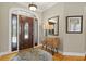 Inviting foyer features hardwood floors, a stylish entry table, and a decorative front door at 5373 Anthony Ln, Sarasota, FL 34233