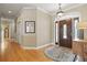 Elegant foyer featuring hardwood floors, recessed lighting, and a decorative front door at 5373 Anthony Ln, Sarasota, FL 34233