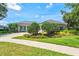 Charming single-story home featuring a well-manicured lawn, mature landscaping, and a spacious driveway at 5373 Anthony Ln, Sarasota, FL 34233