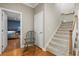 Hallway with hardwood floors, leading to carpeted stairs, overlooking the living room at 5373 Anthony Ln, Sarasota, FL 34233