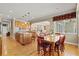 Bright kitchen features a center island, adjacent dining area, and wooden cabinetry at 5373 Anthony Ln, Sarasota, FL 34233