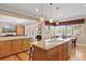 Gourmet kitchen with granite countertops and a breakfast bar offering views of the dining area and living room at 5373 Anthony Ln, Sarasota, FL 34233