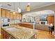 Well-appointed kitchen with granite countertops and seamlessly connects to the cozy living room at 5373 Anthony Ln, Sarasota, FL 34233