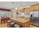 Open kitchen showcases granite countertops, stainless steel appliances, and a breakfast bar at 5373 Anthony Ln, Sarasota, FL 34233