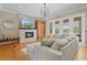 Inviting living room with fireplace, hardwood floors, and natural light from the sliding doors at 5373 Anthony Ln, Sarasota, FL 34233