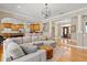 Open-concept living room flowing into the kitchen, complete with hardwood floors and a decorative chandelier at 5373 Anthony Ln, Sarasota, FL 34233