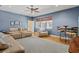 Spacious living room with ceiling fan, seating, hardwood floors, and bright natural light at 5373 Anthony Ln, Sarasota, FL 34233