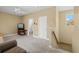 Living room with light colored carpet, and a view into the bathroom and hallway at 5373 Anthony Ln, Sarasota, FL 34233