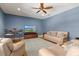 Spacious living room with hardwood floors, ceiling fan, TV, and comfortable seating at 5373 Anthony Ln, Sarasota, FL 34233