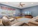 Bright living room with ceiling fan, TV, hardwood floors, seating, and natural light at 5373 Anthony Ln, Sarasota, FL 34233