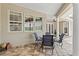 Covered patio featuring a dining set and views of the home and backyard at 5373 Anthony Ln, Sarasota, FL 34233
