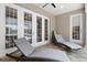Serene covered patio with comfortable lounge chairs, providing an ideal setting for relaxation and leisure at 5373 Anthony Ln, Sarasota, FL 34233