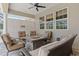 Covered patio features exterior lounge seating and an outdoor fireplace at 5373 Anthony Ln, Sarasota, FL 34233