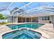 A serene screened-in pool and spa provides the perfect retreat for relaxation and recreation at 5373 Anthony Ln, Sarasota, FL 34233