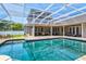 Relaxing pool with brick trimmed patio and a screened in enclosure at 5373 Anthony Ln, Sarasota, FL 34233