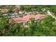 Beautiful aerial of community buildings, landscaping and parking near a fountain and pond at 5401 Bentgrass Dr # 1-113, Sarasota, FL 34235
