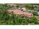 Beautiful view of community buildings with landscaping and parking near a pond and fountain at 5401 Bentgrass Dr # 1-113, Sarasota, FL 34235