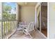 Relaxing balcony space complete with a dining set and a view of the greenery and landscape at 5401 Bentgrass Dr # 1-113, Sarasota, FL 34235