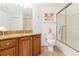 Bathroom with vanity, granite countertop, and a glass-enclosed shower at 5401 Bentgrass Dr # 1-113, Sarasota, FL 34235