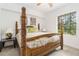 Bright bedroom with a four-poster bed, and large window at 5401 Bentgrass Dr # 1-113, Sarasota, FL 34235