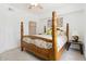 Bedroom with a four-poster bed, ceiling fan, and natural light at 5401 Bentgrass Dr # 1-113, Sarasota, FL 34235