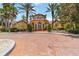 Stunning clubhouse with a circular design, grand entrance, and manicured landscaping at 5401 Bentgrass Dr # 1-113, Sarasota, FL 34235
