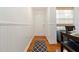 Charming entryway with hardwood floors, wainscoting, and a dining area at 5401 Bentgrass Dr # 1-113, Sarasota, FL 34235
