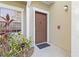 Inviting front door with a modern design, white trim, and a well-maintained exterior at 5401 Bentgrass Dr # 1-113, Sarasota, FL 34235