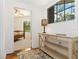 Bright hallway with a decorative table and a glimpse into the bedroom at 5401 Bentgrass Dr # 1-113, Sarasota, FL 34235
