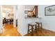 Cozy kitchen features wood floors, wood cabinets, granite countertops, and eat-in bar space at 5401 Bentgrass Dr # 1-113, Sarasota, FL 34235