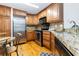 Well-equipped kitchen with stainless steel appliances, granite countertops, and wood cabinets at 5401 Bentgrass Dr # 1-113, Sarasota, FL 34235