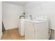 Well-lit laundry area with a washing machine, dryer, and convenient shelving for storage at 5401 Bentgrass Dr # 1-113, Sarasota, FL 34235