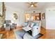 Inviting living room boasts a stone accent wall, hardwood floors, and a reclining sofa at 5401 Bentgrass Dr # 1-113, Sarasota, FL 34235