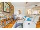 Living room with a stone accent wall, hardwood floors, reclining sofa, and stylish decor at 5401 Bentgrass Dr # 1-113, Sarasota, FL 34235
