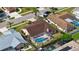 Aerial view of a home with a screened-in pool, highlighting its location within the neighborhood at 5613 Sweetwater Oak Dr, Sarasota, FL 34232