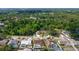 Bird's-eye view of property, nestled among mature trees and neighboring homes, featuring a screened-in pool at 5613 Sweetwater Oak Dr, Sarasota, FL 34232