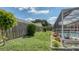Well-manicured backyard featuring lush greenery and a screened-in pool at 5613 Sweetwater Oak Dr, Sarasota, FL 34232