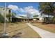 Well-maintained building with connecting walkways and lush green landscaping, creating a welcoming exterior view at 5613 Sweetwater Oak Dr, Sarasota, FL 34232