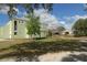 Lush, green park area with a glimpse of the well-maintained building featuring a connected outdoor walkway at 5613 Sweetwater Oak Dr, Sarasota, FL 34232