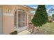 Close up of front door with decorative security door and well maintained landscaping at 5613 Sweetwater Oak Dr, Sarasota, FL 34232