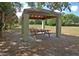 Covered picnic pavilion with several picnic tables, offering a shaded area for outdoor enjoyment at 5613 Sweetwater Oak Dr, Sarasota, FL 34232