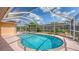 Inviting screened-in pool with a brick-lined border, offering a private outdoor retreat at 5613 Sweetwater Oak Dr, Sarasota, FL 34232