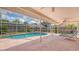 Relaxing screened-in pool area with lounge chairs and well-maintained patio at 5613 Sweetwater Oak Dr, Sarasota, FL 34232