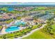 Panoramic aerial of the community showcasing a pool area, tennis courts, and green spaces at 5624 Palmer Cir # 206, Bradenton, FL 34211