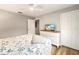 Bedroom featuring light gray walls, wood floors, and a flat screen TV on a white dresser at 5624 Palmer Cir # 206, Bradenton, FL 34211