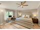 Inviting bedroom with lots of light, a work desk, and a wood ceiling fan at 5624 Palmer Cir # 206, Bradenton, FL 34211