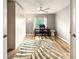 Light and airy bedroom with a large area rug, and a ceiling fan with a light at 5624 Palmer Cir # 206, Bradenton, FL 34211