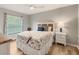 Cozy bedroom featuring a ceiling fan, wood floors, and a plush bed with a 'Relax' pillow at 5624 Palmer Cir # 206, Bradenton, FL 34211